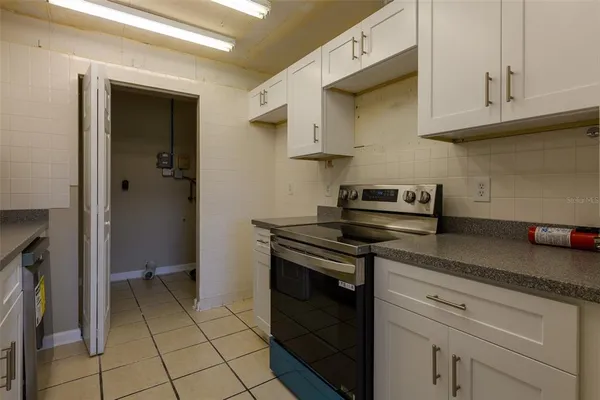 a kitchen with stainless steel appliances granite countertop a stove and a cabinets