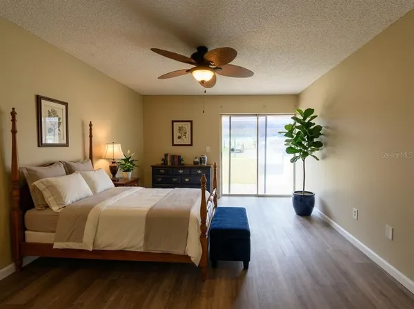 a bedroom with bed and a potted plant