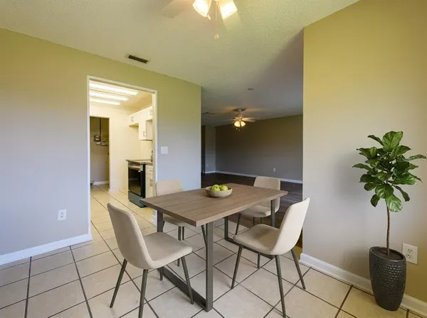 a view of a dining room with furniture and a potted plant