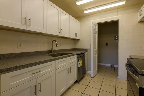 a kitchen with a sink and cabinets