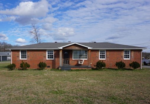 9547 Old Hillsboro Road Bon Aqua, TN 37025 - Photo 1 of 13 a front view of a house with garden