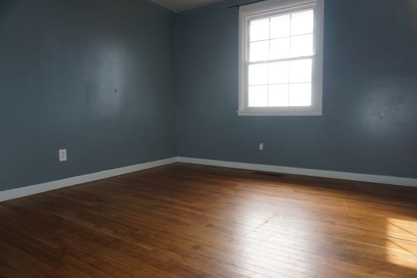 9547 Old Hillsboro Road Bon Aqua, TN 37025 - Photo 12 of 13 an empty room with wooden floor and windows