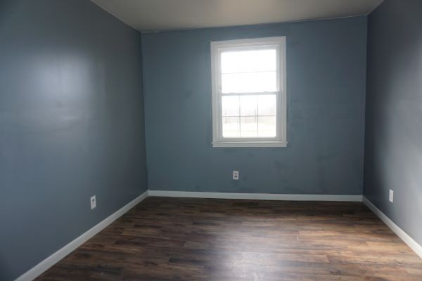 9547 Old Hillsboro Road Bon Aqua, TN 37025 - Photo 13 of 13 an empty room with wooden floor and windows