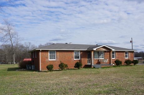 9547 Old Hillsboro Road Bon Aqua, TN 37025 - Photo 2 of 13 a front view of a house with a garden