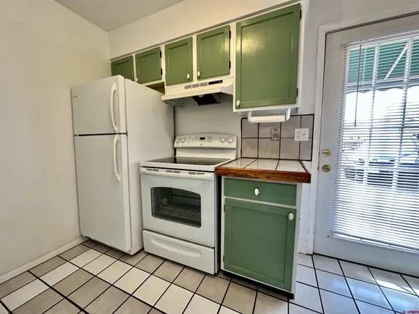 a kitchen with a refrigerator and a washing machine