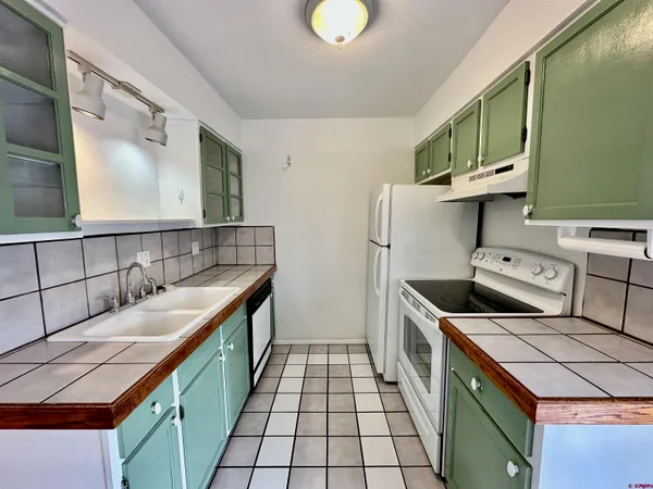 a kitchen with stainless steel appliances granite countertop a sink and stove