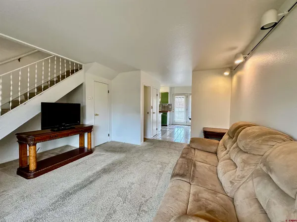 a bedroom with furniture and a flat screen tv