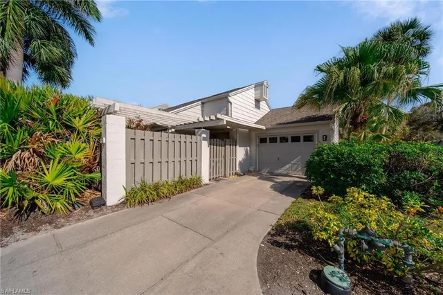 a front view of a house with a yard and a garage