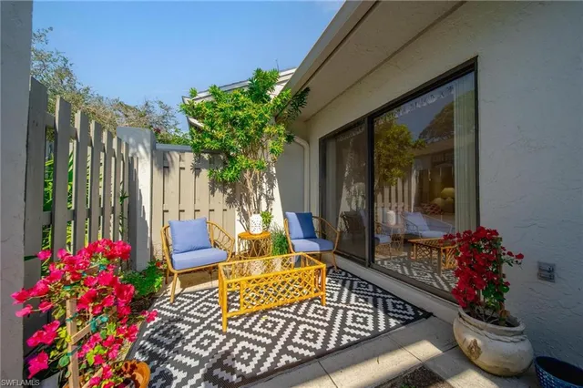 a front view of a house with outdoor seating