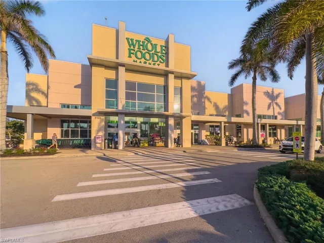 a front view of a house with a garden and parking space