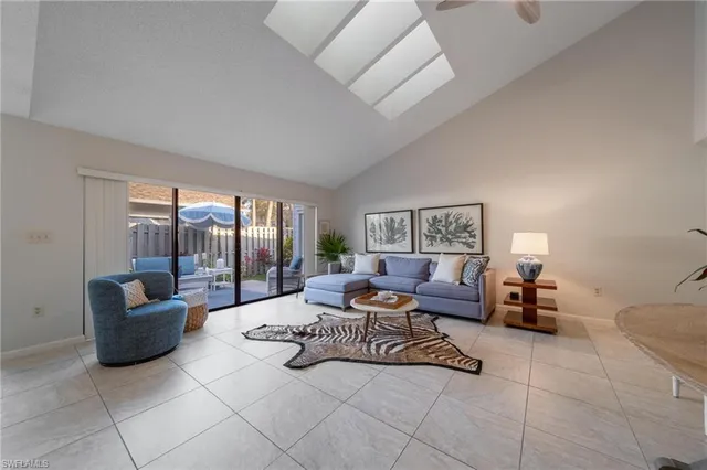 a living room with furniture and a lamp