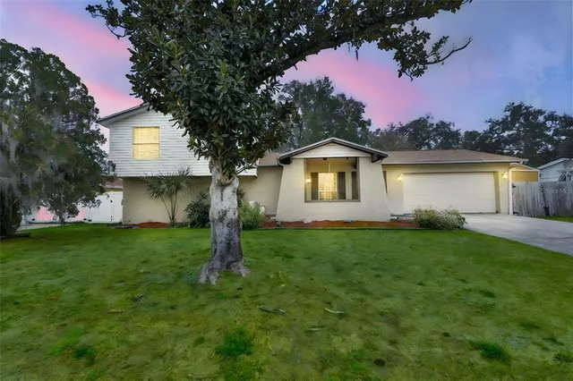 a front view of a house with a garden and yard