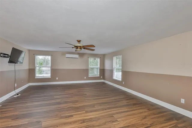 wooden floor in an empty room with a window