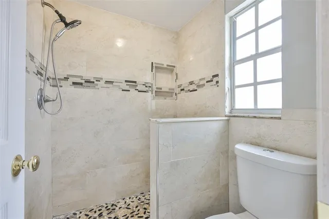 a bathroom with a shower and toilet