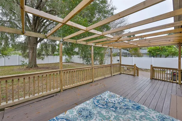 a view of a roof deck with wooden floor and fence
