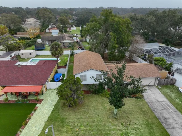 an aerial view of a house with garden space and street view