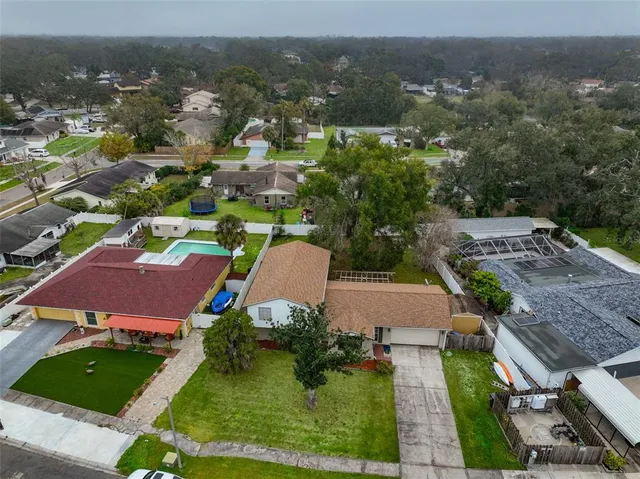 an aerial view of multiple houses with yard
