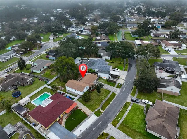 an aerial view of a houses with yard