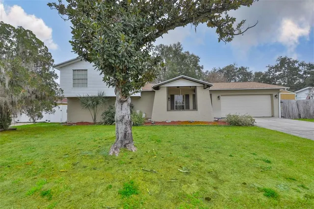 a front view of house with yard and trees