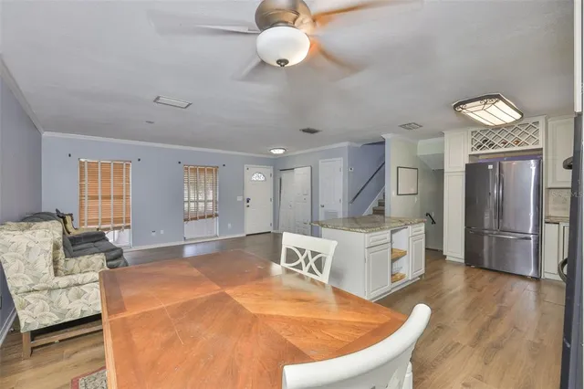 a living room with furniture and kitchen view