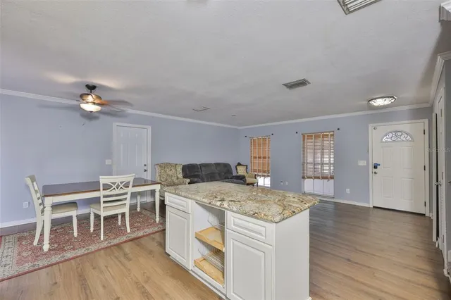 a view of kitchen with sink microwave and refrigerator