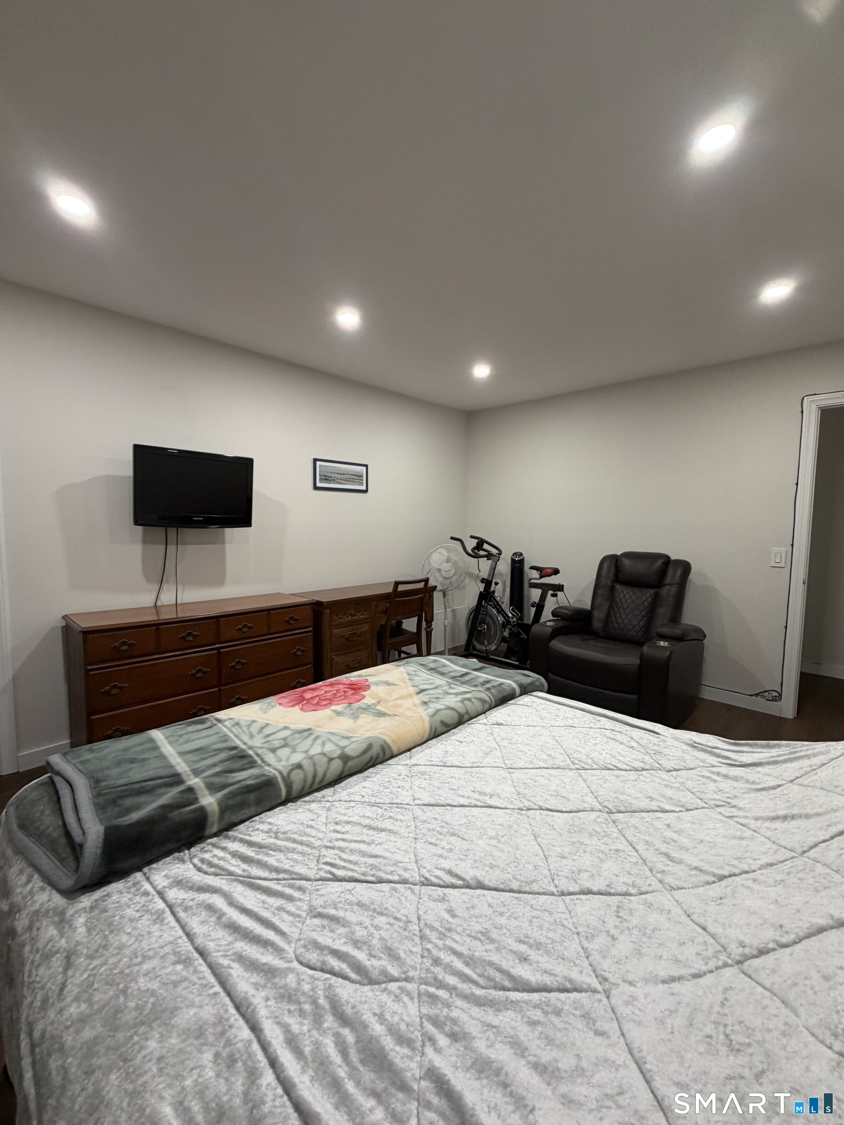 131 Florence Road, Unit 1C Branford, CT 06405 - Photo 12 of 18 a bedroom with a bed and a flat screen tv