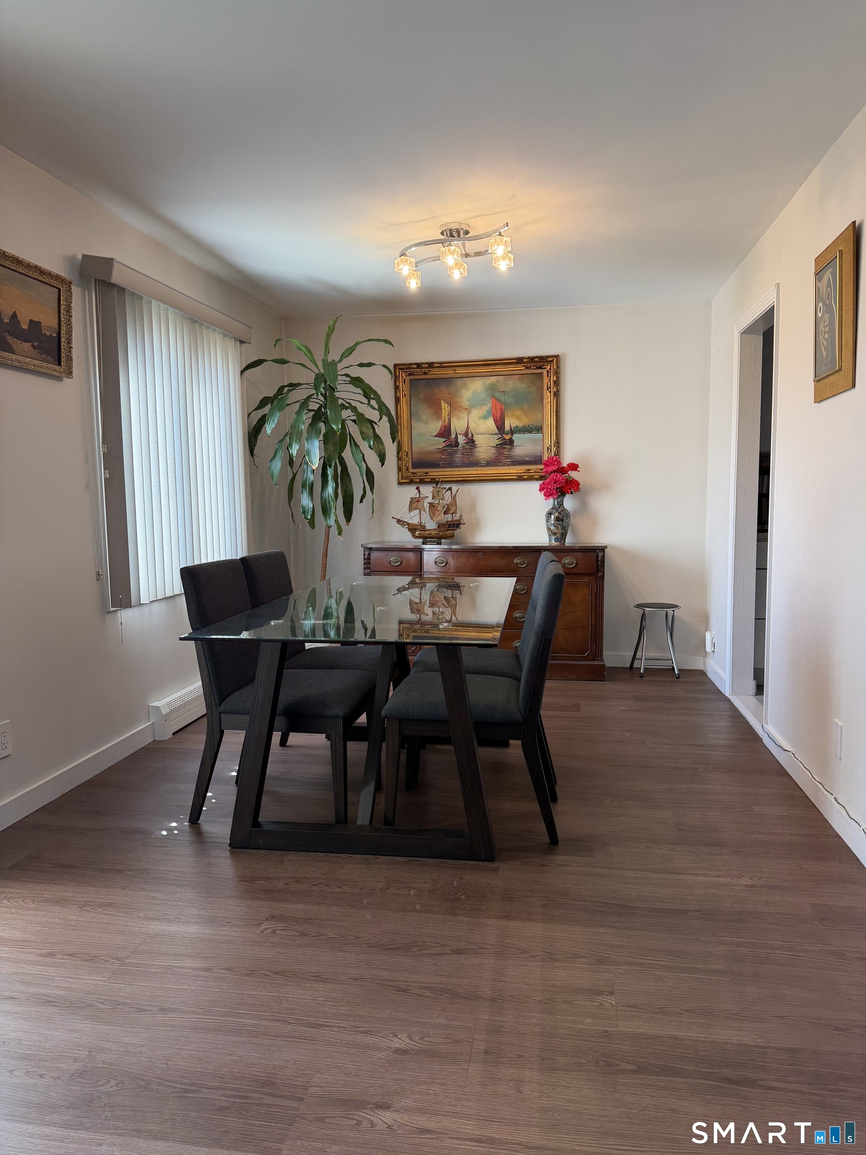 131 Florence Road, Unit 1C Branford, CT 06405 - Photo 4 of 18 a view of a dining room with furniture and wooden floor