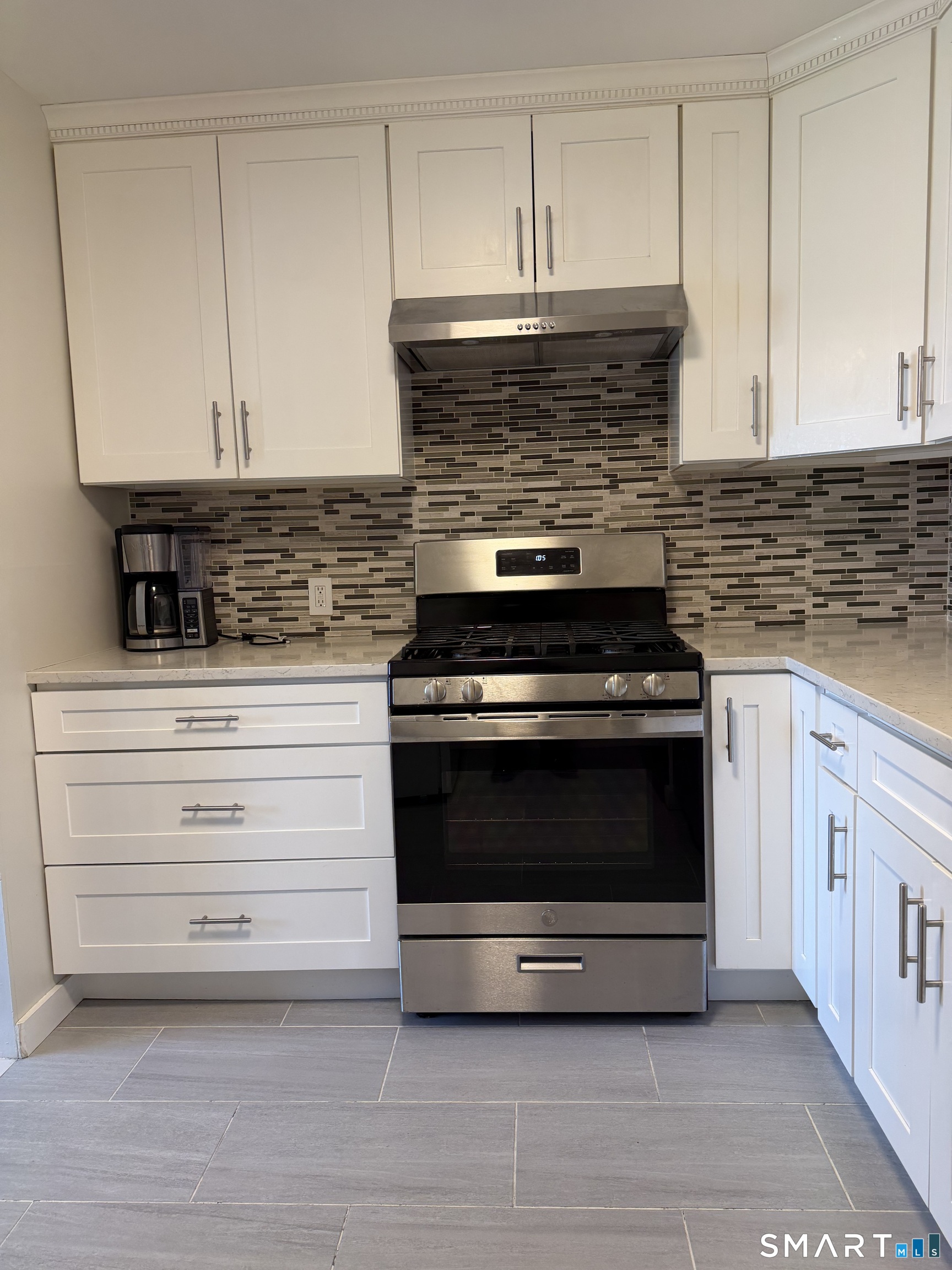 131 Florence Road, Unit 1C Branford, CT 06405 - Photo 5 of 18 a kitchen with granite countertop a stove and a microwave