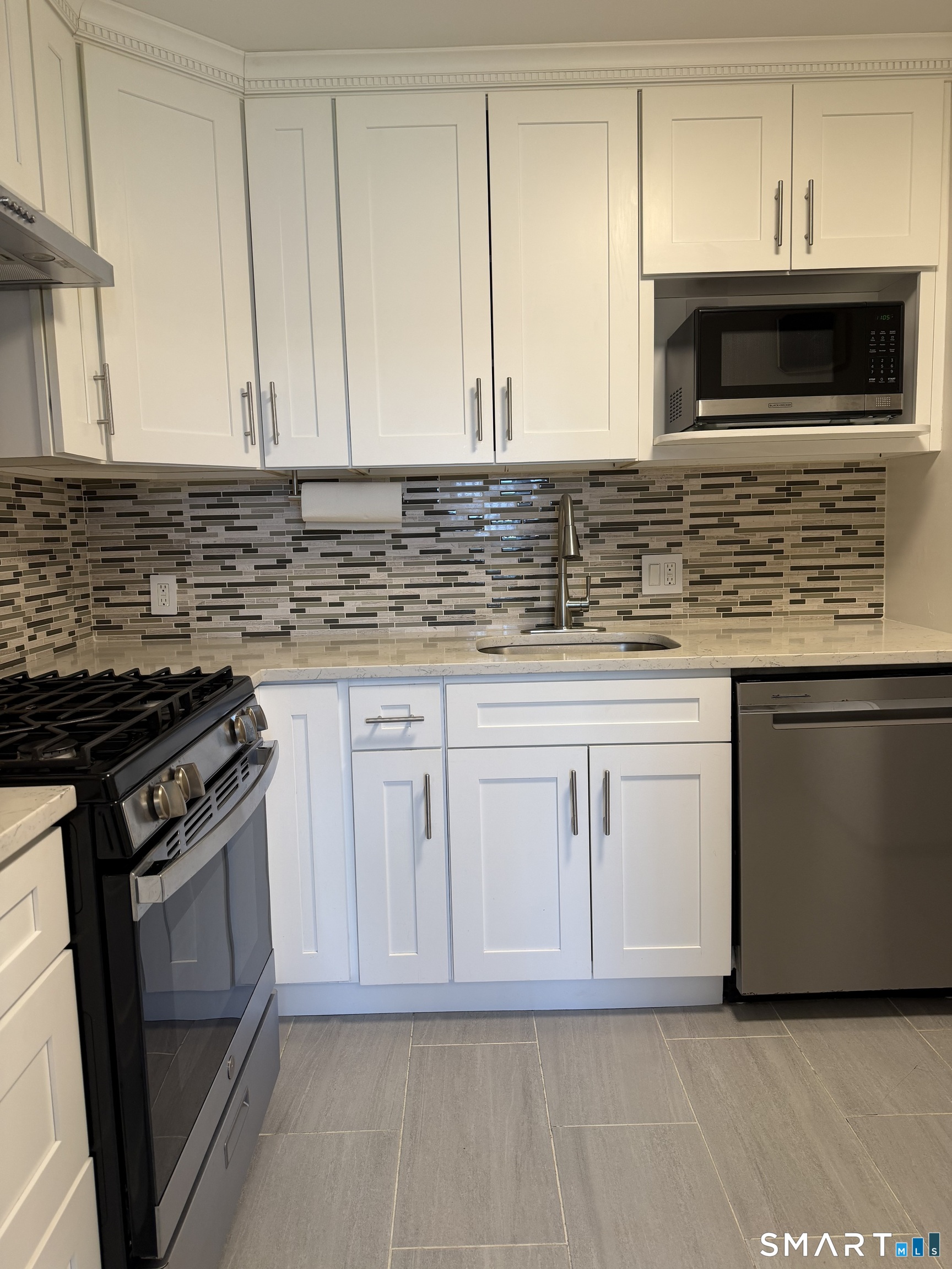 131 Florence Road, Unit 1C Branford, CT 06405 - Photo 6 of 18 a kitchen with granite countertop white cabinets and stainless steel appliances