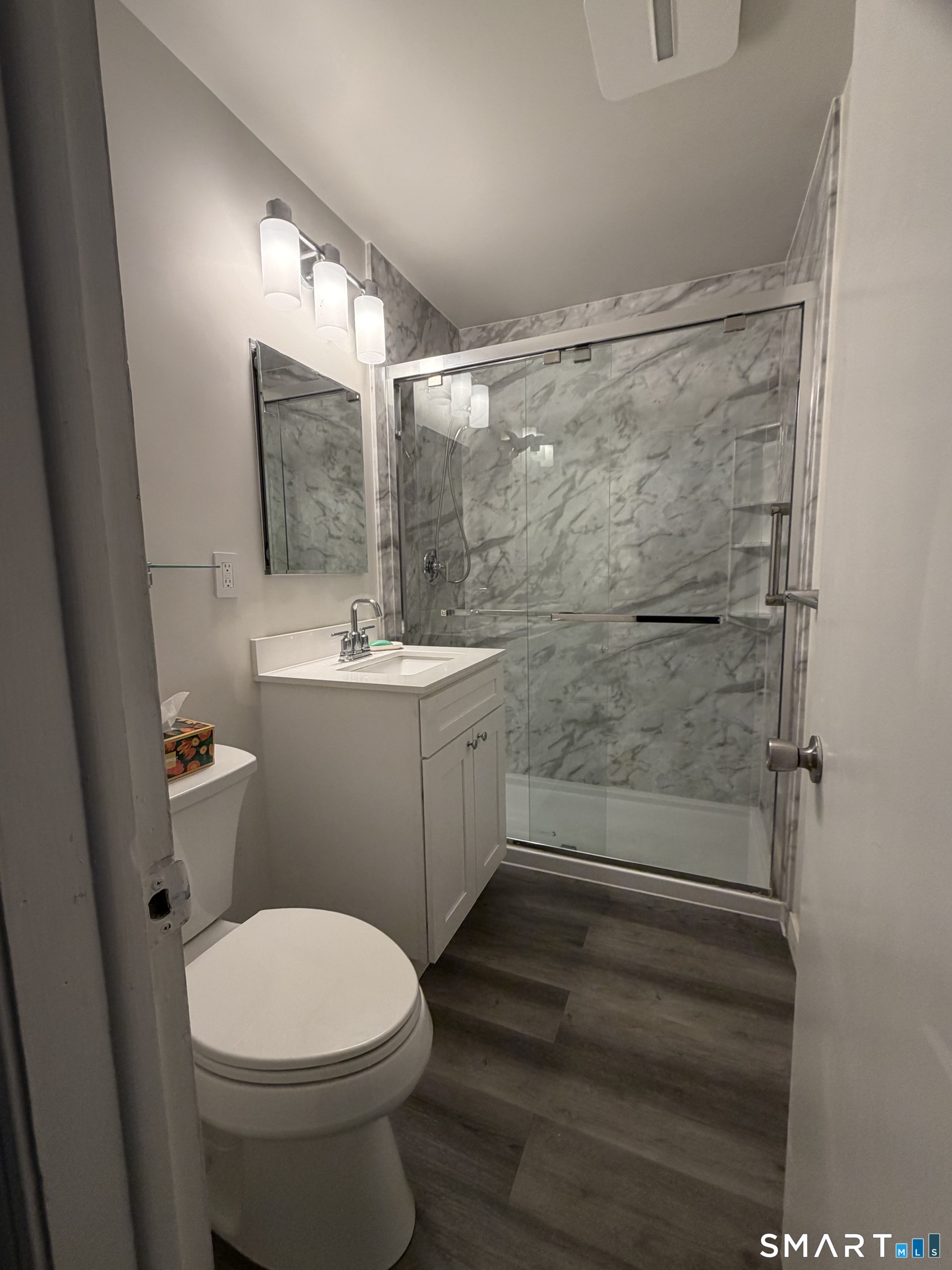 131 Florence Road, Unit 1C Branford, CT 06405 - Photo 9 of 18 a bathroom with a sink a toilet and shower