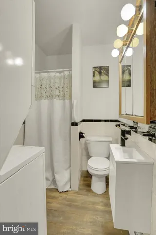 a kitchen with stainless steel appliances granite countertop a refrigerator a sink dishwasher a stove and wooden floors