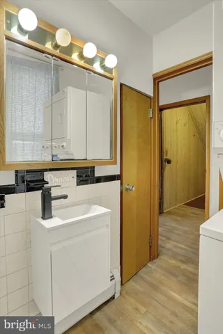a kitchen with sink cabinets and wooden floor