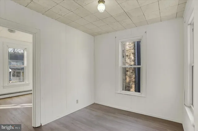 a view of an empty room with wooden floor