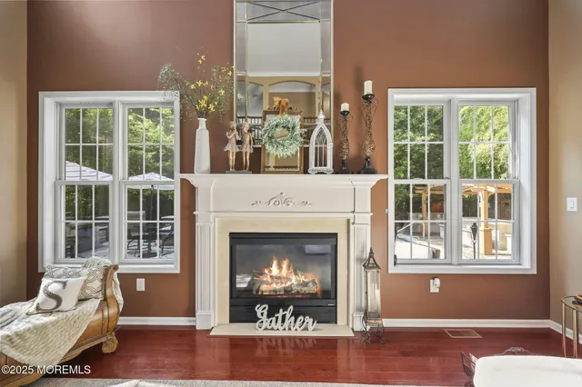 a kitchen with stainless steel appliances granite countertop a refrigerator a sink a stove a dining table and chairs