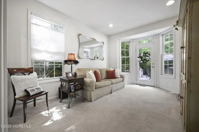 a view of hallway with wooden floor and windows