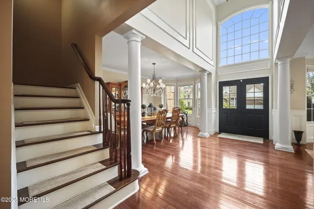 a spacious bedroom with a bed and a flat screen tv