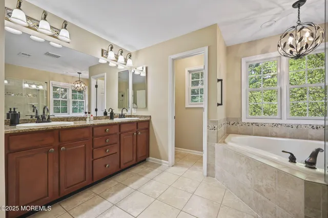 a bathroom with a double vanity sink toilet and a mirror