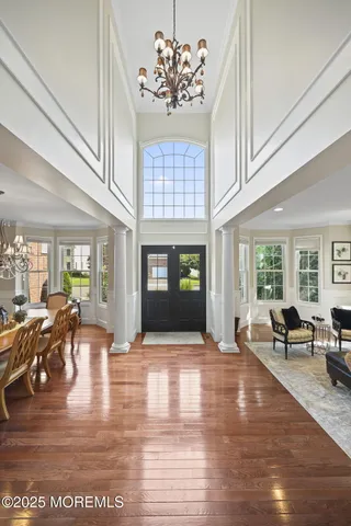 a view of a dining room with furniture and a chandelier
