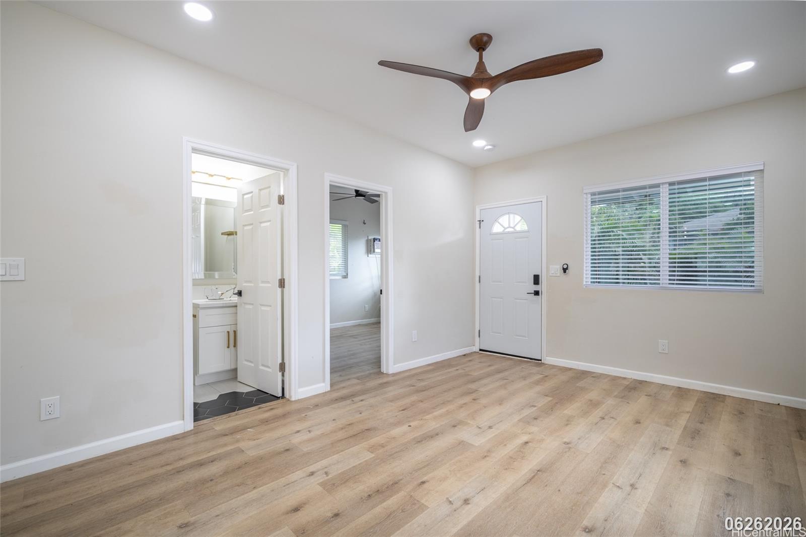 87-1409 Akowai Road Waianae, HI 96792 - Photo 10 of 25 wooden floor in an empty room with a window