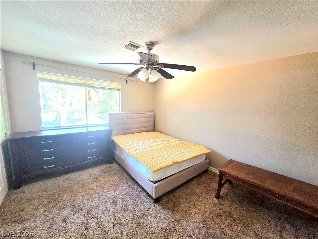 3648 Bronco Road Las Vegas, NV 89103 - Photo 24 of 24 A well-lit bedroom featuring a spacious window and a practical ceiling fan.