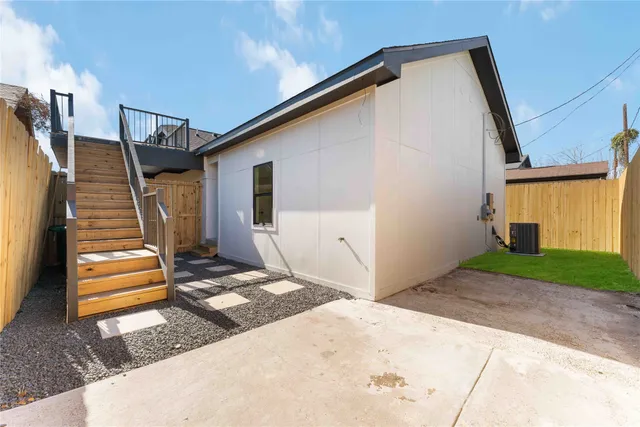 a backyard of a house with wooden floor and fence