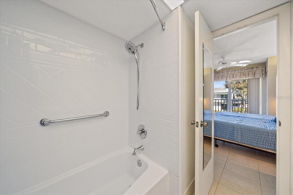 902 Gibbs Road, Unit 282 Venice, FL 34285 - Photo 9 of 19 a bathroom with a tub and a shower