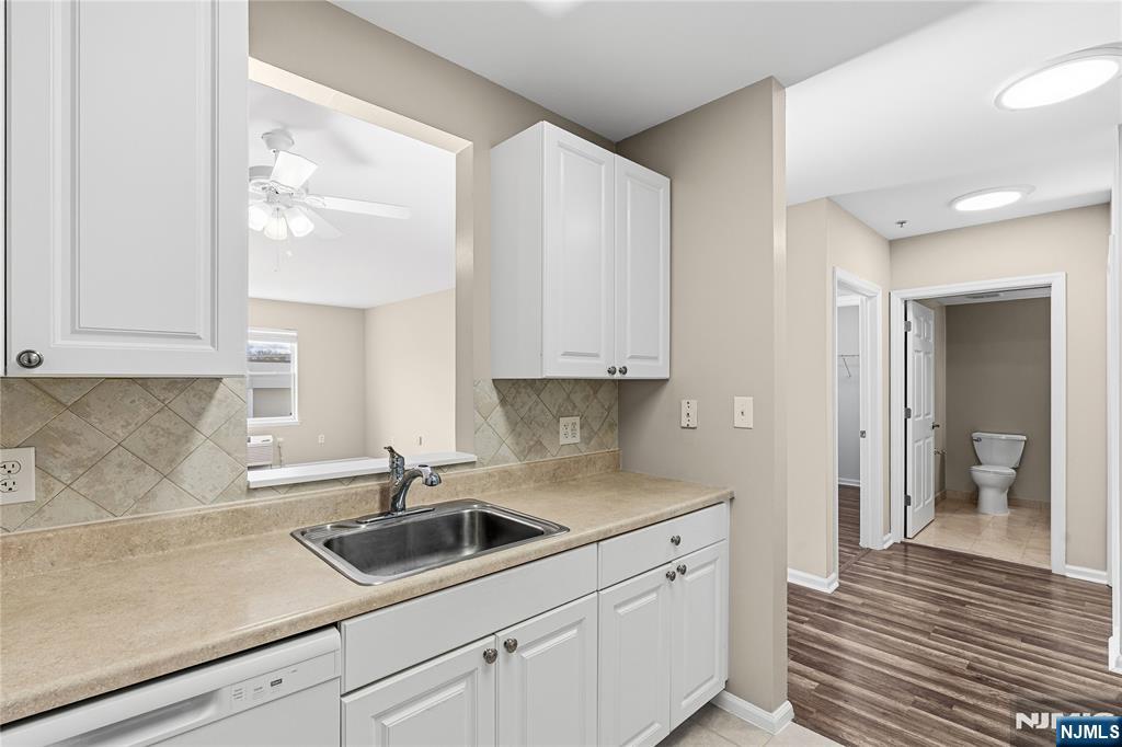 905 River Road, Unit 202 Edgewater, NJ 07020 - Photo 13 of 35 a kitchen with a sink and cabinets