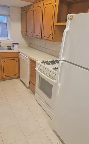 a kitchen with a stove top oven and white countertops