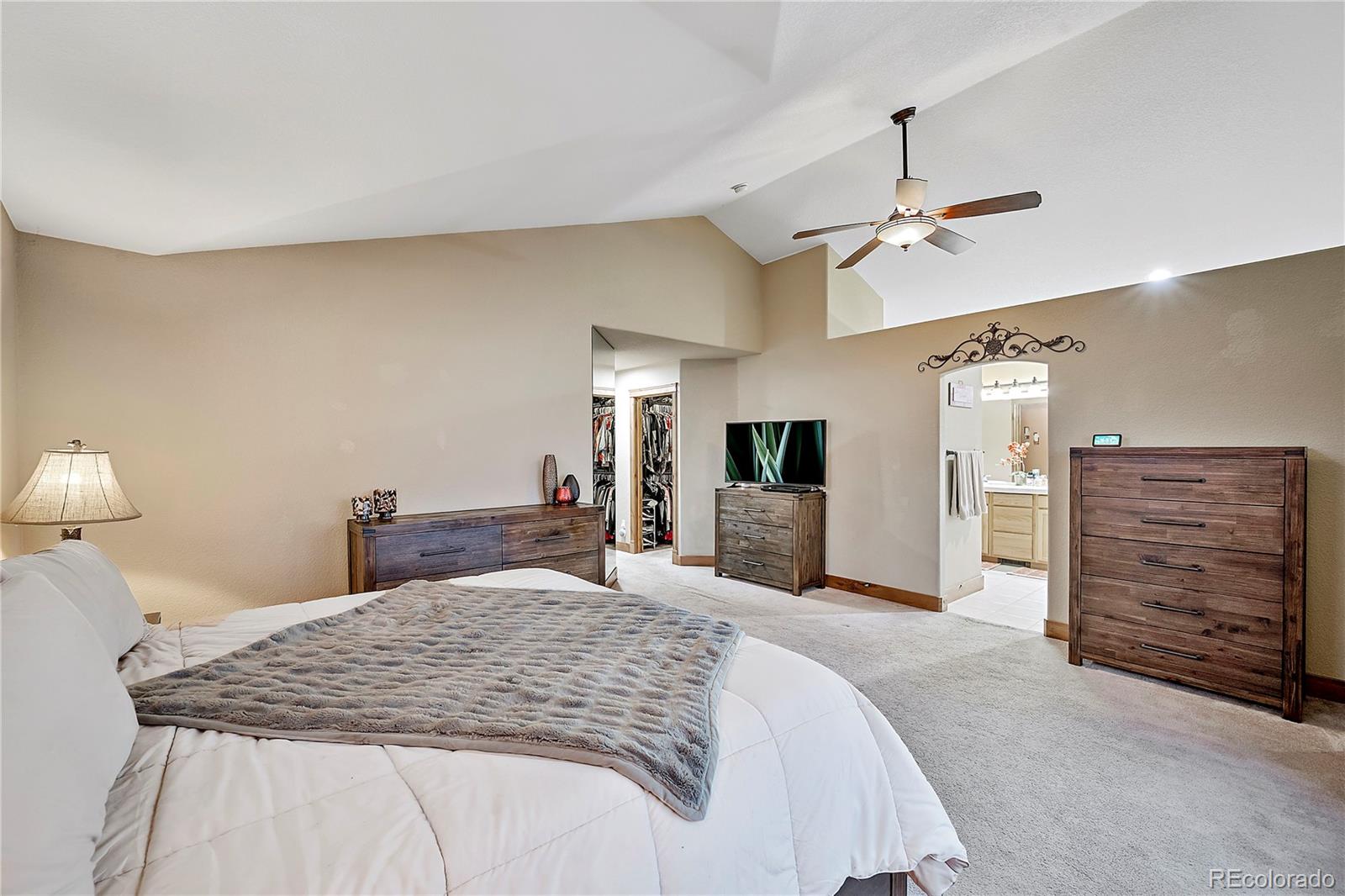 855 Gregory Circle Parker, CO 80138 - Photo 20 of 37 a bedroom with a large bed and a dresser