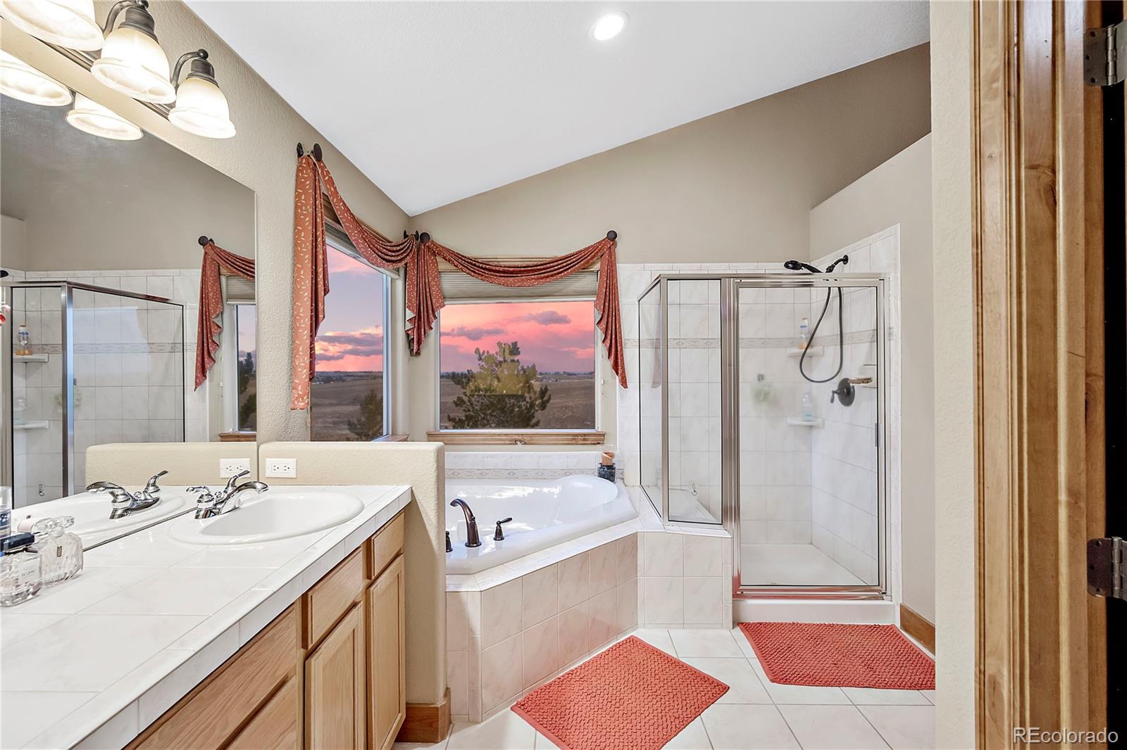 855 Gregory Circle Parker, CO 80138 - Photo 21 of 37 a bathroom with a sink a mirror a bathtub and shower