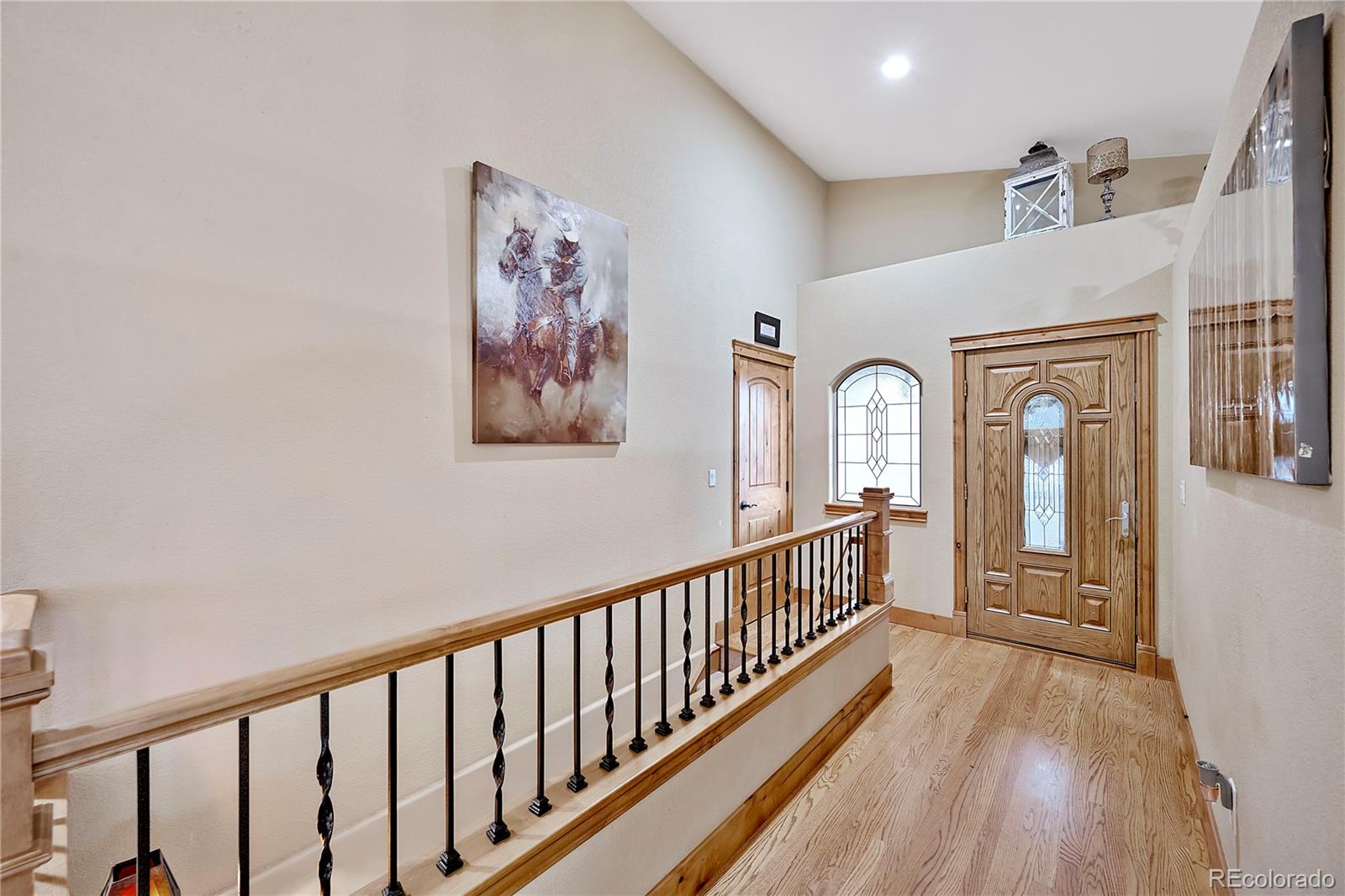 855 Gregory Circle Parker, CO 80138 - Photo 33 of 37 a view of a hallway with wooden floor and windows