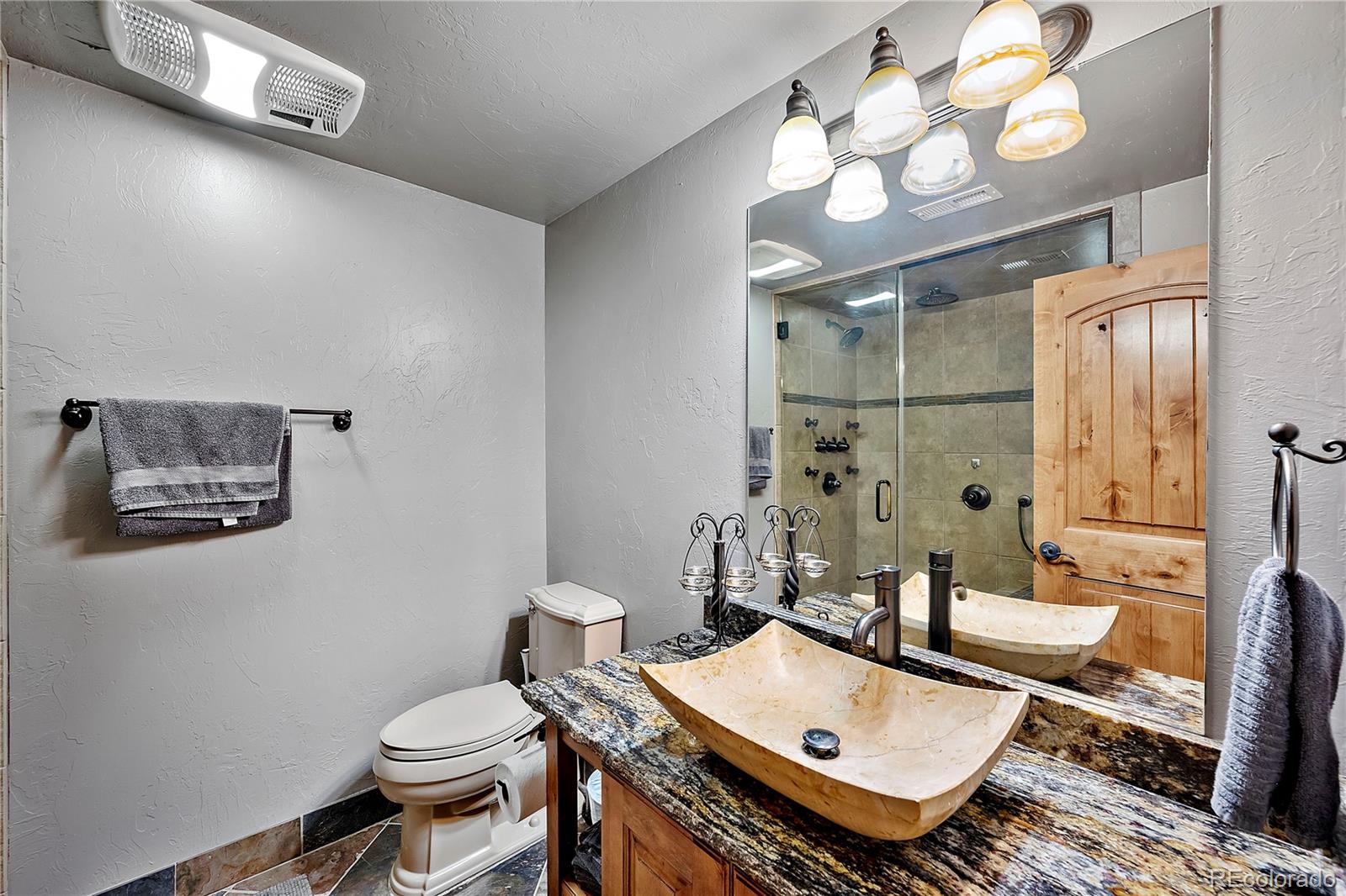 855 Gregory Circle Parker, CO 80138 - Photo 34 of 37 a bathroom with a sink a toilet and a mirror