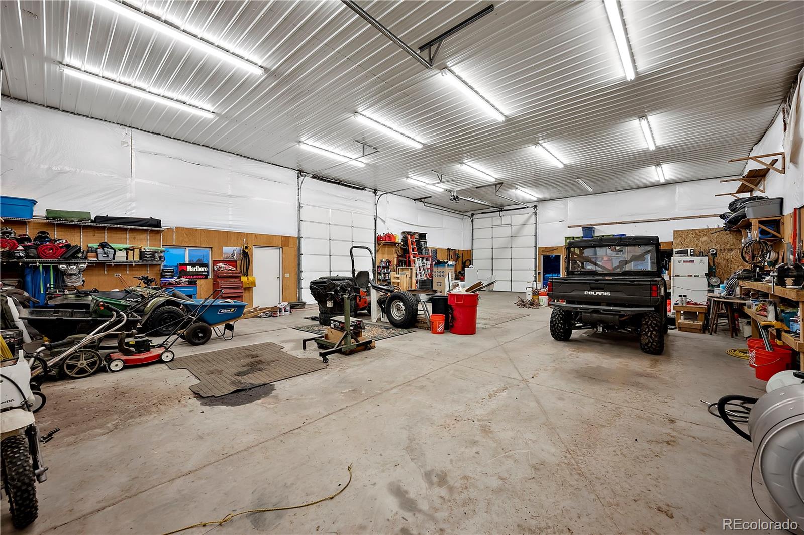 855 Gregory Circle Parker, CO 80138 - Photo 7 of 37 a view of a garage with a bike and a car