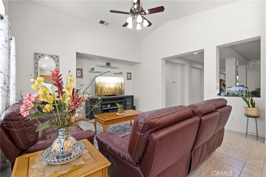 33145 Vermont Road Temecula, CA 92592 - Photo 13 of 41 a living room with furniture a chandelier and a mirror